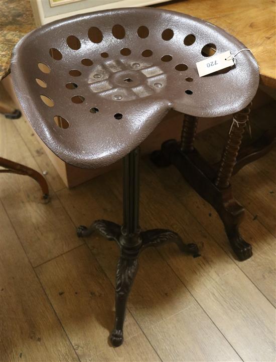 A cast iron base tractor seat stool